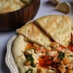 Hummus on a plate with pita bread