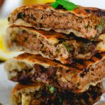 Arayes- Meat Stuffed Pita on a brown plate