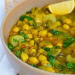 Harira Soup in a brown bowl with a lemon
